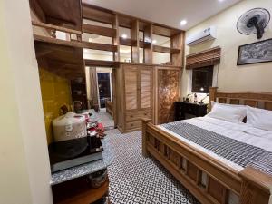 a bedroom with a large bed and a kitchen at Anam Homestay in Ho Chi Minh City +25 photos
