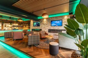 a lobby with a bar with chairs and a fireplace at Appartement in Marina Kamperland in Kamperland