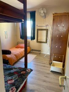 a bedroom with two bunk beds and a mirror at The Flying Carpet - Crater Camel Mount View in Mitzpe Ramon