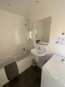 a bathroom with a toilet and a sink and a shower at Le Cube in Nayemont-les-Fosses