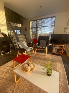 a living room with a table and a living room with a tv at Le Cube in Nayemont-les-Fosses