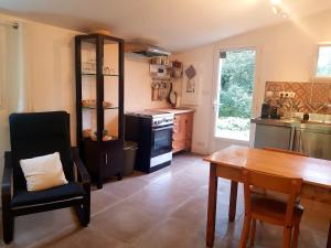 a kitchen with a wooden table and a dining room at Beautiful studio surrounded by nature in Lanet