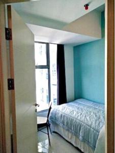 a bedroom with a bed and a room with a window at Benson Tower Surabaya Apartment 2BR by Le Ciel Hospitality in Lontar