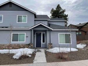 a gray house with a blue door at Family friendly 4-bdrm 3.5 bath w guest suite in Flagstaff