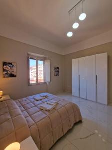 a large bedroom with a large bed and a window at L'Elisir Home in Caserta