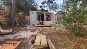 a tiny house in the woods with a bench at Casita entre dunas al son del mar in Salinas 
