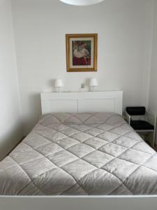 a bed in a bedroom with a picture on the wall at Casa Simo Apartment in Castel di Sangro