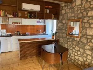 a kitchen with a wooden counter and a table at Apartment Naval in Dubrovnik