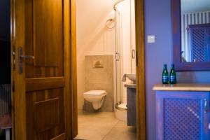 a bathroom with a toilet and a sink and a door at Karolowy Dwór in Wisła