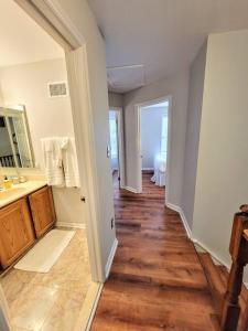 a bathroom with a sink and a wooden floor at Awesome Home in suburb Washington DC near Airport with WiFi and Parking in Herndon