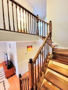 a staircase in a home with wooden floors and a stair case at Awesome Home in suburb Washington DC near Airport with WiFi and Parking in Herndon
