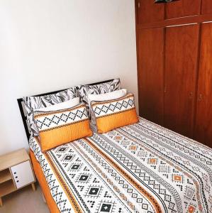 a bed with two pillows on top of it at Un punto- 2 Bedroom Apartment in San Miguel de Allende