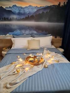 a bed with a tray of lights on it at Mountain Peak Apartment in Borovets