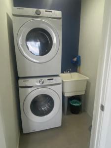 a washing machine and a sink in a bathroom at La Vue de Basseterre Apartments - Luxury in Bird Rock in Basse Terre Town