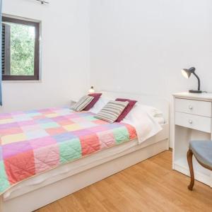 une chambre avec un lit et un bureau avec une lampe dans l'établissement Joso Dalmatia, à Vir