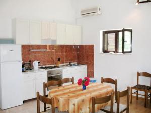 a kitchen with a table with flowers on it at Joso Dalmatia in Vir