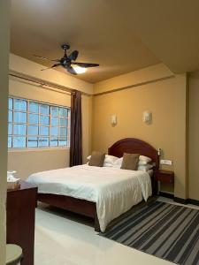a bedroom with a bed and a ceiling fan at ilaa Beach Maldives in Gulhi