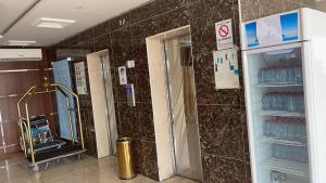 a bathroom with a shower and a glass door at شقق مساكن الراية المخدومه in Al Khobar