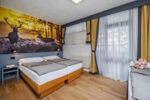 Postel nebo postele na pokoji v ubytování Pippo Hotel + 37 fotografií
