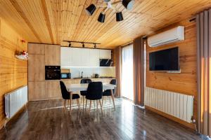 a kitchen with a dining room table and chairs at Eco house villa jeo in Tbilisi City