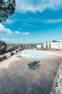 two lounge chairs and a swimming pool on a patio at Luxusvilla Casaabel in Roca Llisa