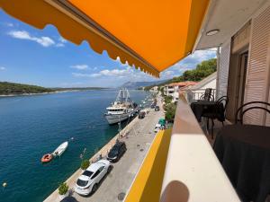 a balcony with a view of the water and boats at Apartman Blaga in Povlja
