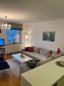 a living room with a couch and a table at Apartment Pine in Bjelašnica