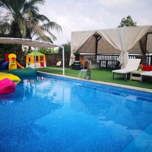 a swimming pool with a tent in the background at צימר חן בחד נס in Had Nes