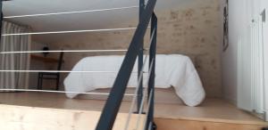 a room with a white bed in a room at L orchidée in Saint-Martin-de-Saint-Maixent