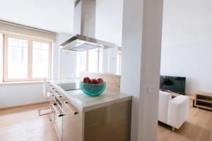 a kitchen with a bowl of fruit on a counter at New Exclusive 2 Bedroom Apartment in OldRiga in Rīga