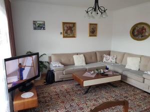 a living room with a couch and a tv at Visoko Homestay in Visoko