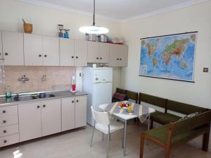 a kitchen with a table and a couch and a table and chairs at Asprovalta Beach Apartment in Asprovalta