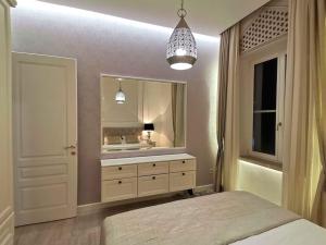a bedroom with a bed and a sink and a mirror at Minderluk in Sarajevo +2 photos