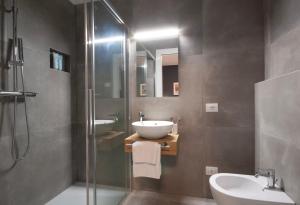 a bathroom with a sink and a glass shower at Affittacamere Casa Maria in San Giovanni Ilarione