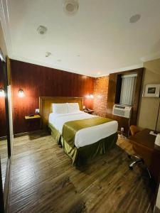 a hotel room with a large bed and wooden floors at The Architect in Washington, D.C.