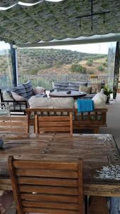 a table and chairs and pillows on a roof at Vivienda rural del salado in Jaén