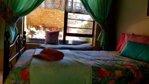 a bedroom with a bed and a window at Tiny's Getaway in Jeffreys Bay