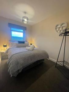 a bedroom with a large bed with a window at Normsy Place Seaside Serenity Breath Taking Views in St Bees