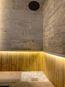 a room with a shower with a stone wall at The Palms Resort (2) in Riyadh