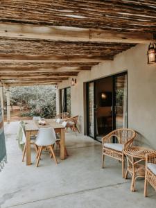 a patio with a wooden table and chairs at UmnDeni Africa in Hoedspruit