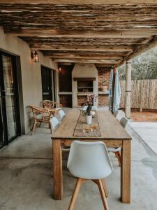 a wooden table and chairs on a patio at UmnDeni Africa in Hoedspruit