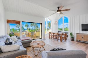 a living room with a couch and a table at Honu He'e Nalu - The Surfing Turtle - Ocean & Beachfront! Stunning Views! in Koloa