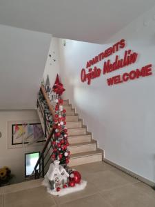 a staircase with christmas ornaments on the stairs at Apartments Medulin - Orijeta in Medulin