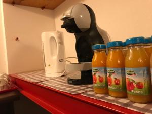 un mostrador con botellas de zumo de naranja y una licuadora en L'Albore en Costigliole Saluzzo