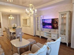 een woonkamer met een tv en een eetkamer bij Beograd na Vodi - BW ARCADIA LUXURY in Belgrado