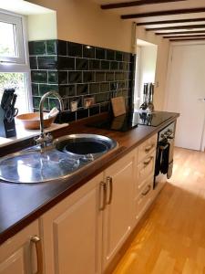 a kitchen with a sink and a counter top at Ivy House Barn, Heckington in Heckington