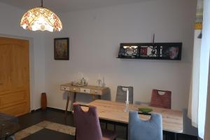a dining room with a wooden table and chairs at Müllers Wellness Ferienhaus in Döbrököz