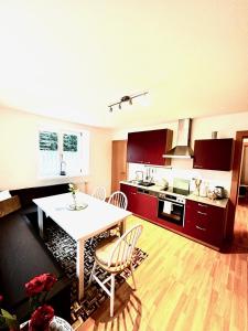 a kitchen with a table and chairs in a room at Sternenhimmel Gamlitz FeWo 3 SZ in Gamlitz +34 photos