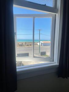 a window with a view of the ocean at Coastal Accommodation in Oamaru