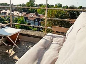 a bench on a balcony with a table and a view at Richmond-On-Thames, London, Luxery Apparment With Balcony in Richmond